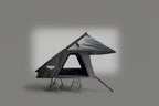 A rooftop tent shown on a gray gradient background.The tent is dark gray/black with a triangular roof shape and visible support legs.