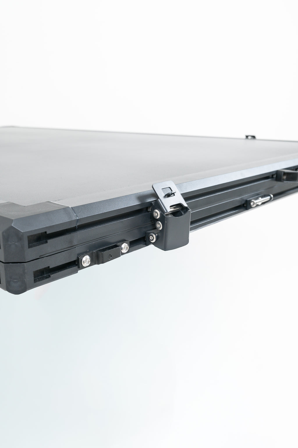 Close up of black rooftop tent on a white background