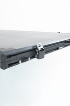 Close up of black rooftop tent on a white background