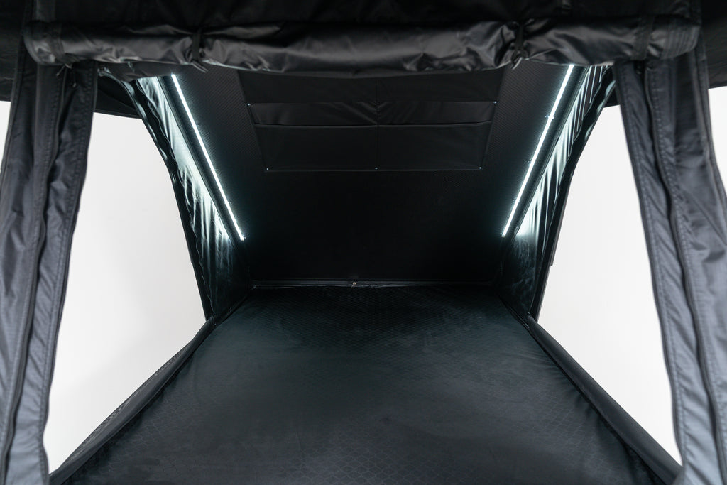 Black interior of a rebellion roof top tent opened