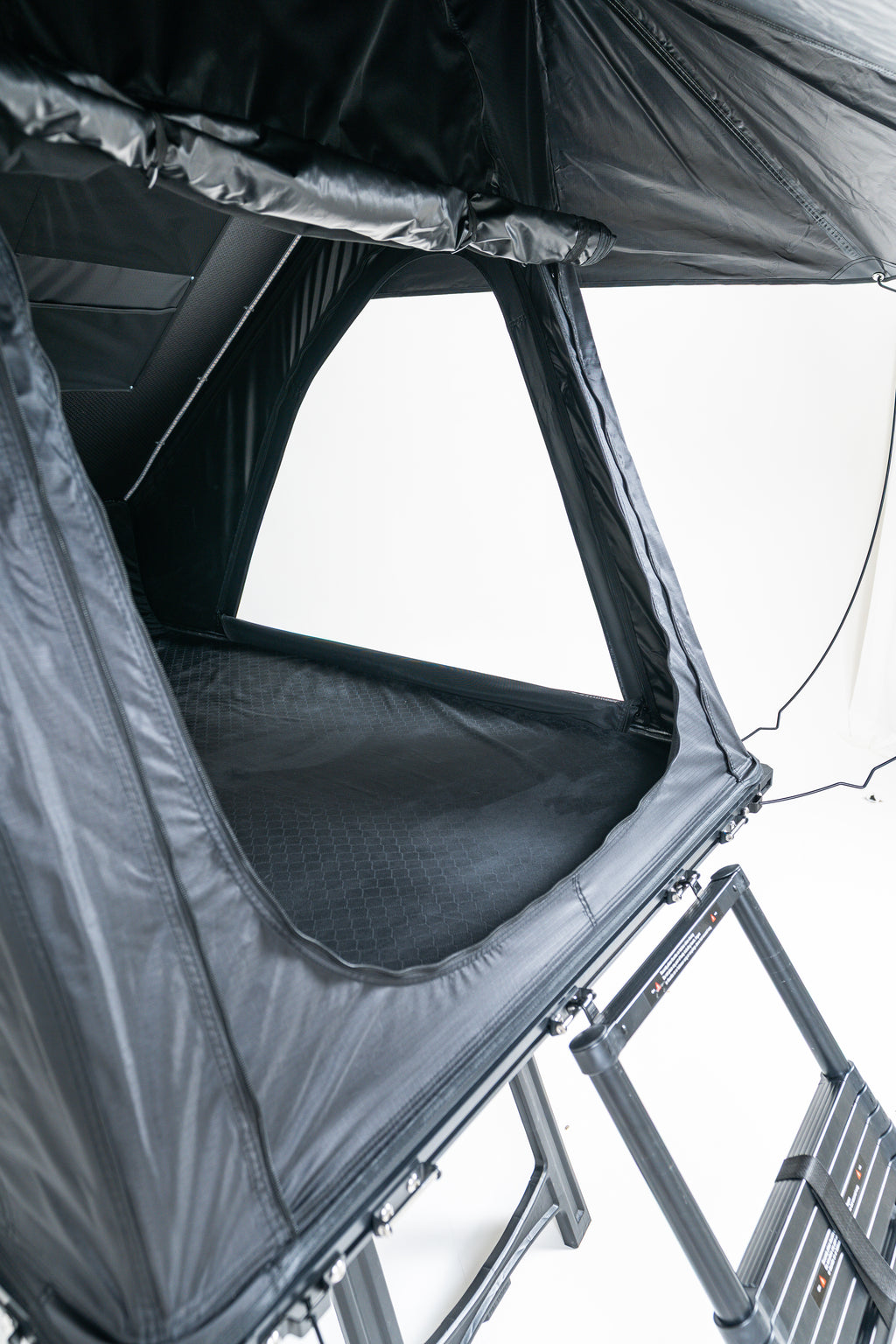 Rooftop tent with open front panel on a white background