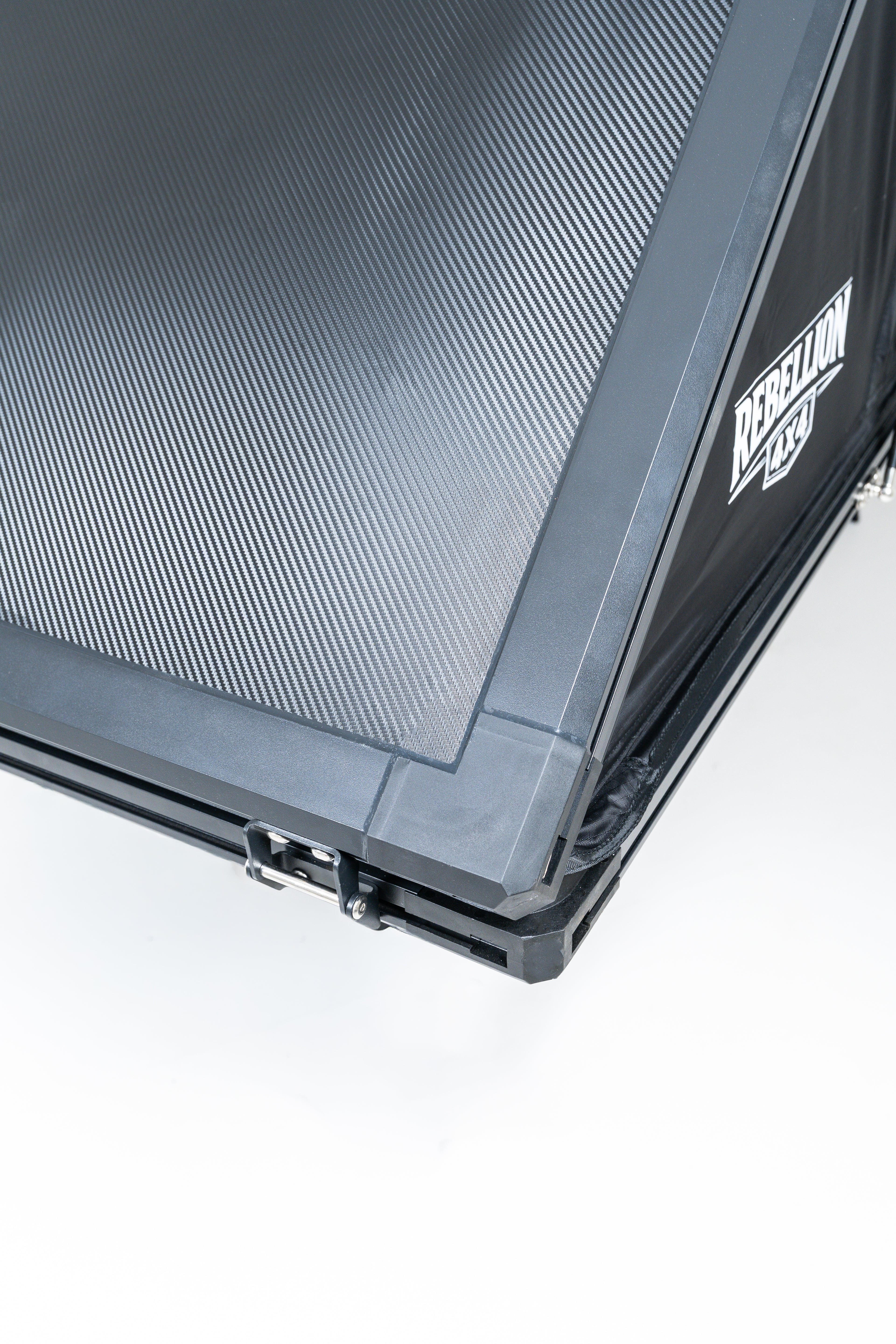 Close up of black carbon rebellion 4x4 rooftop tent on white backround