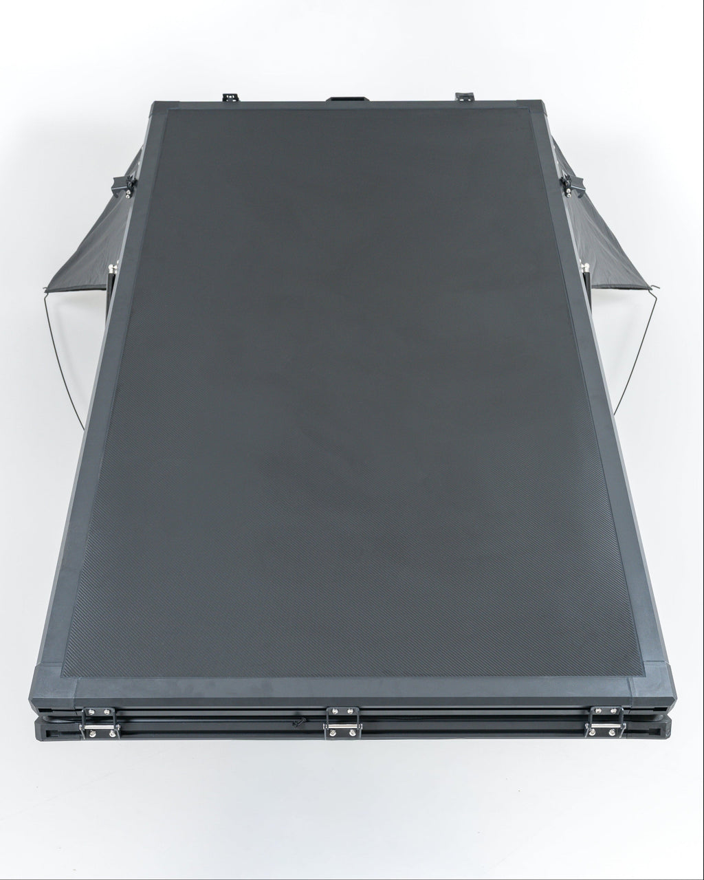 Black carbon roof top tent openin studio with white backround