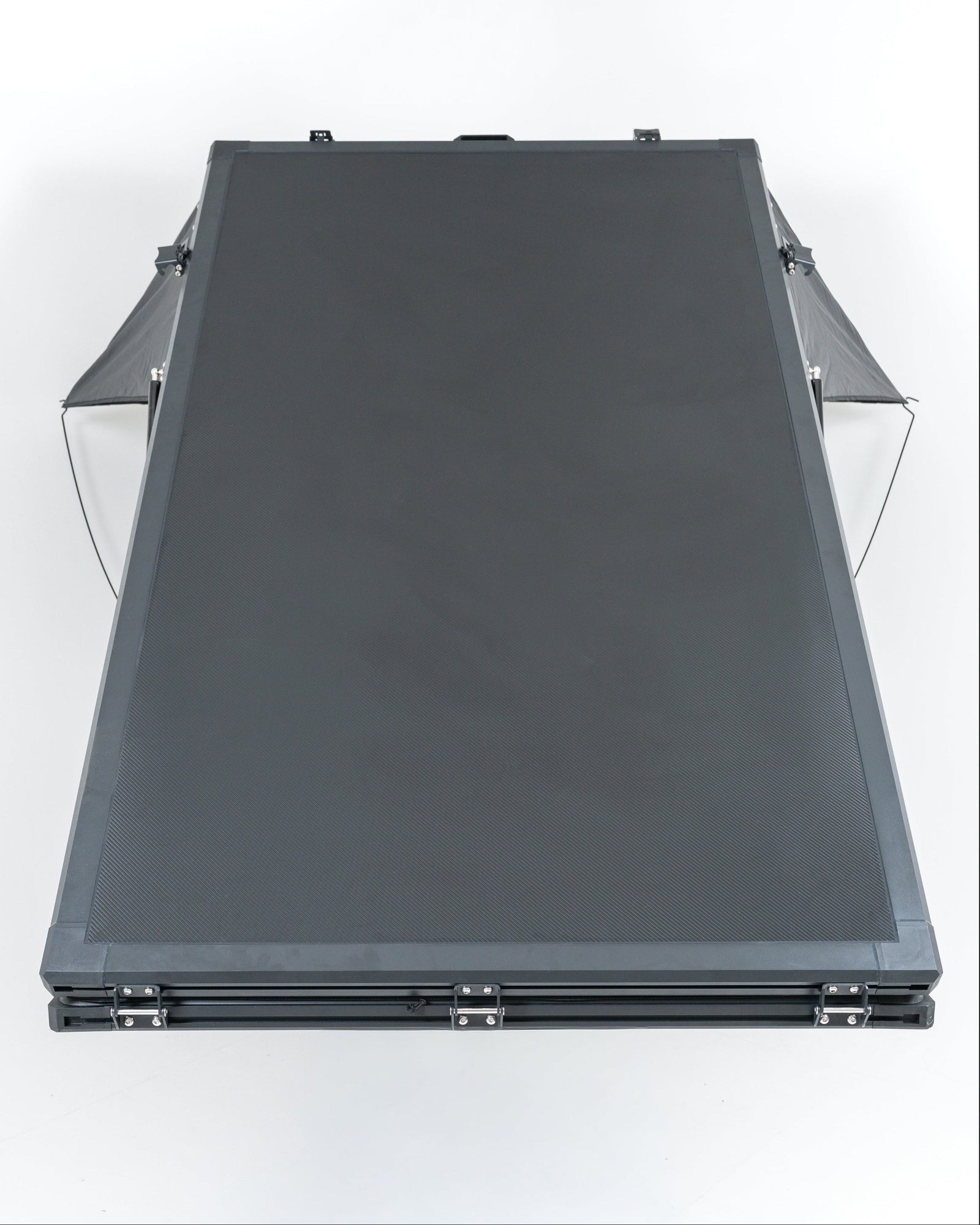 Black carbon roof top tent openin studio with white backround