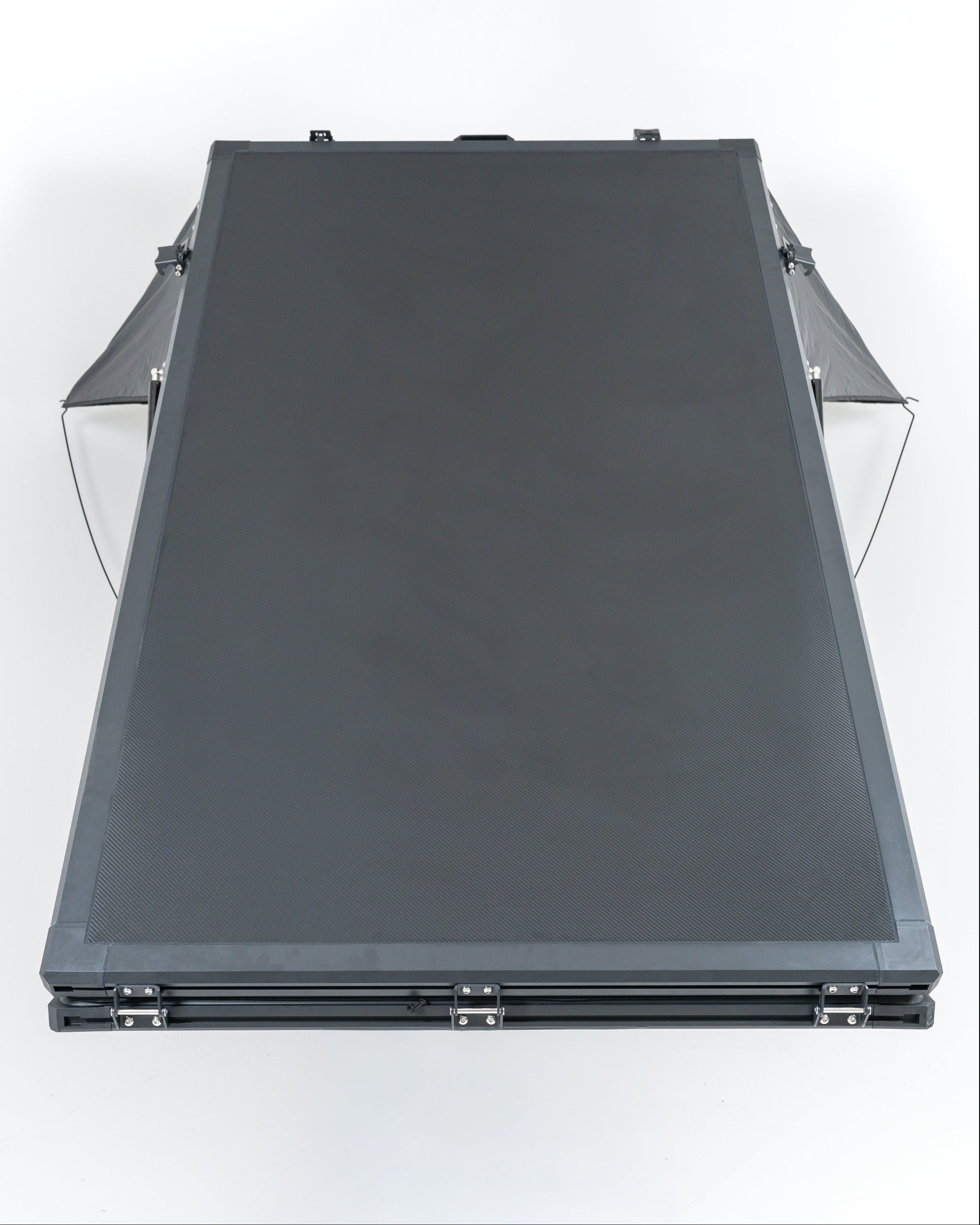 Black carbon roof top tent openin studio with white backround